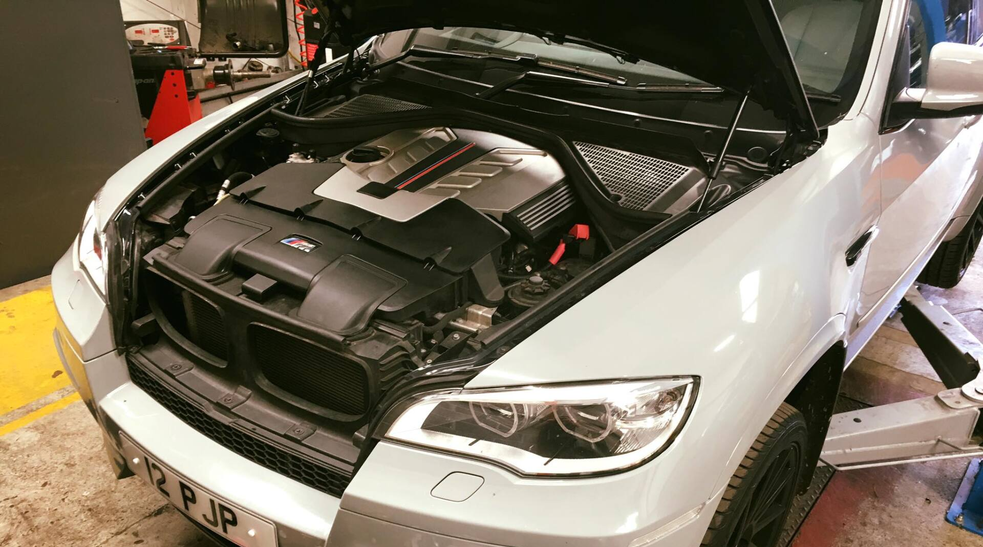 Car being serviced on a ramp at the workshop