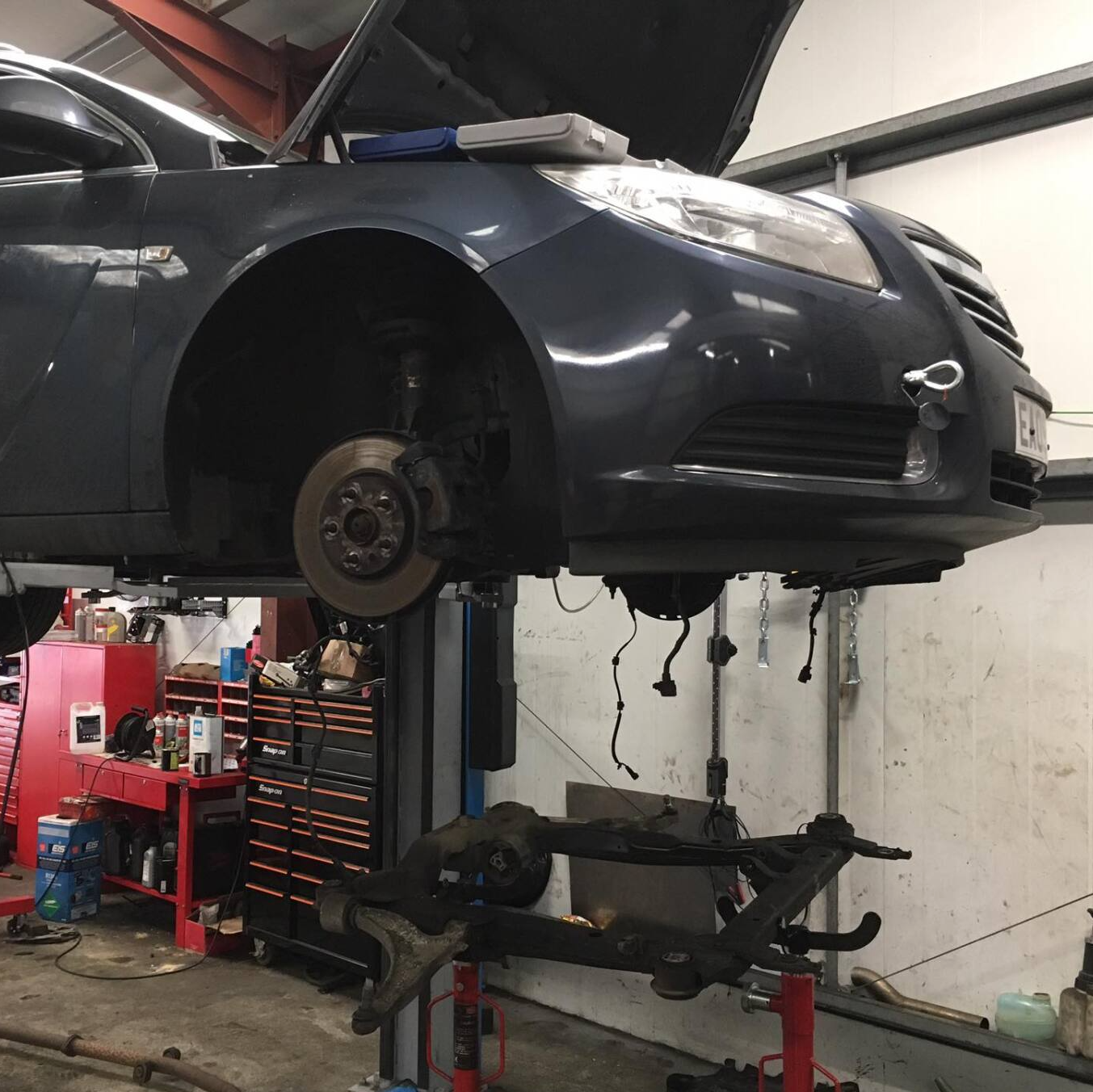 Vehicle repair work underway in the garage